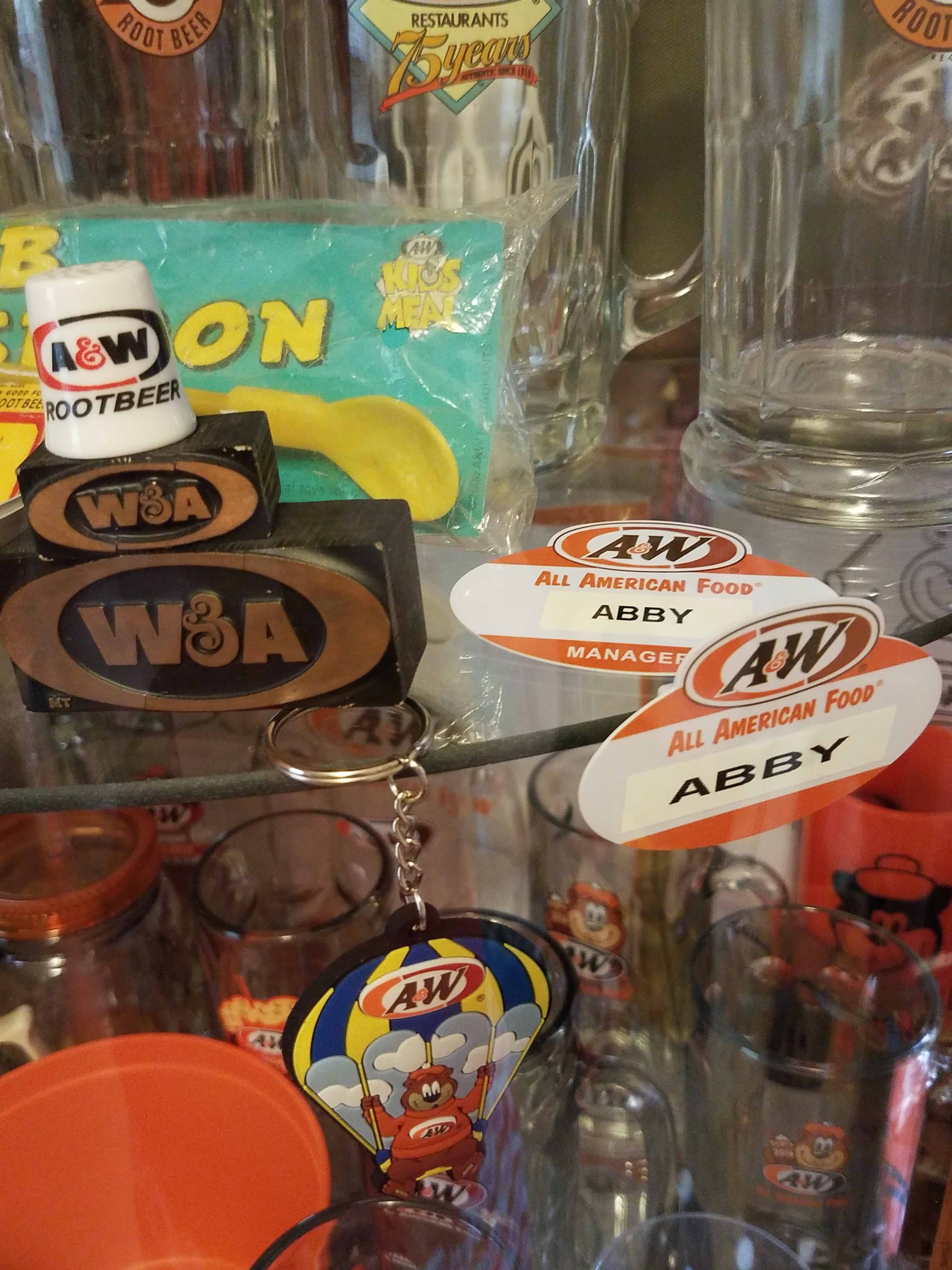 Various vintage A&W Restaurants memorabilia on a shelf