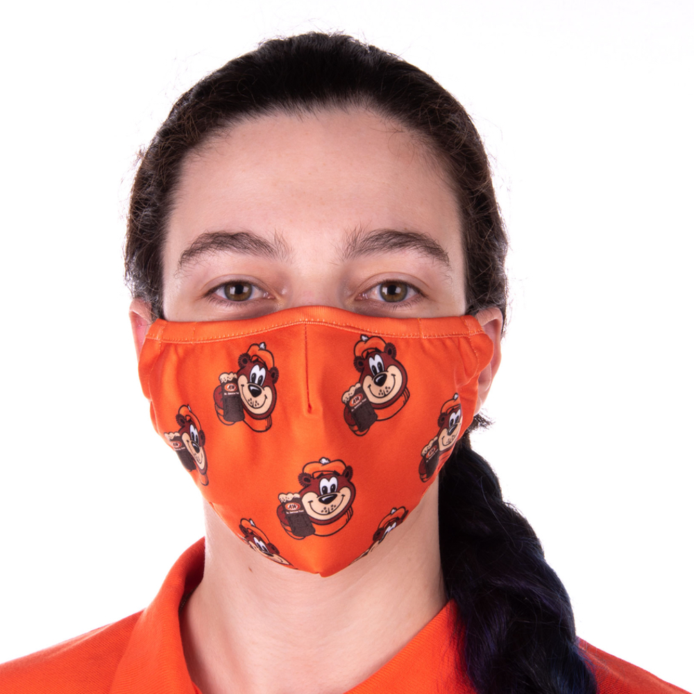 Photo of girl wearing orange face mask featuring icons of Rooty the Great Root Bear