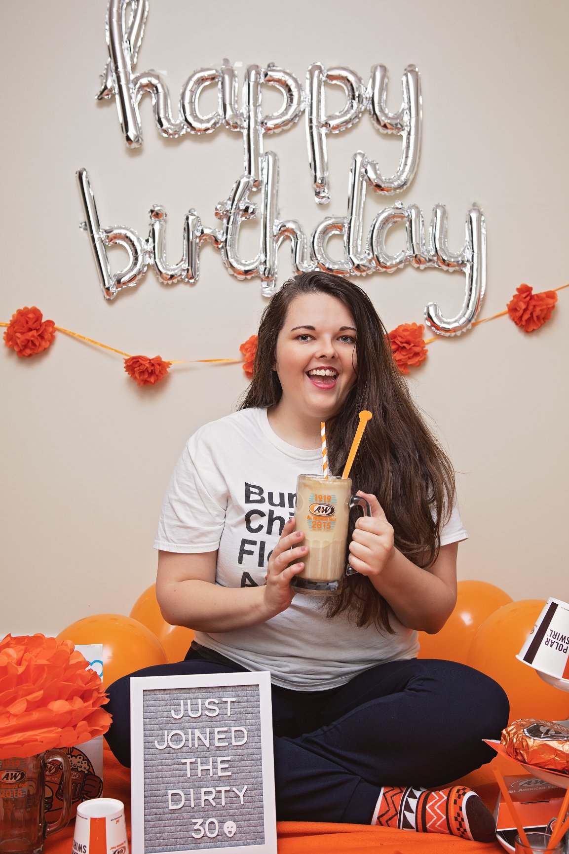 Briana holding root beer float in an A&W mug